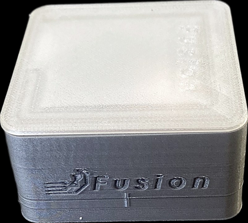 The Ghost Logger: a compact square unit with a frosted clear lid and a dark grey body embossed with the Fusion logo